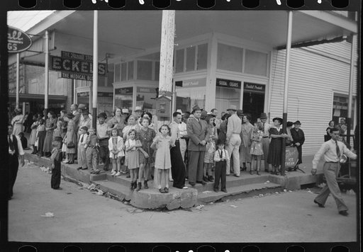 People standing on street corner waiting for parade, National Rice Festival, Crowley, Louisiana