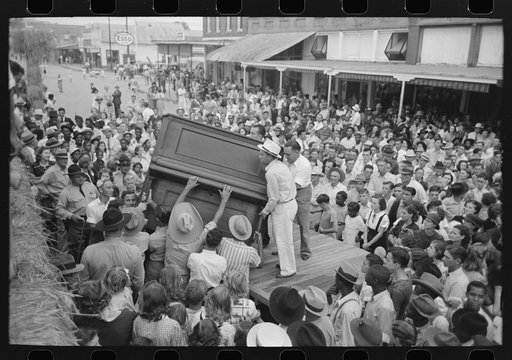 Raising piano from truck to elevated platform for Cajun band contest, National Rice Festival, Crowley, Louisiana