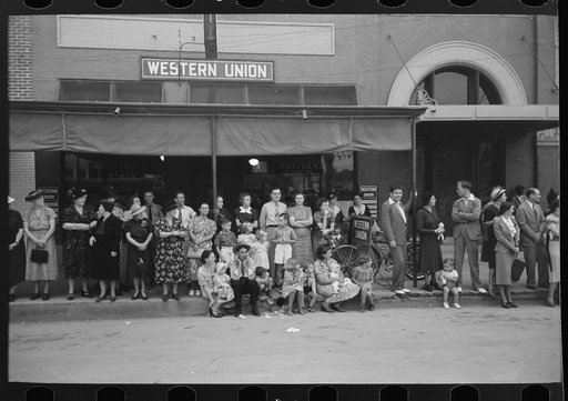 People lined up along sidewalk during parade, National Rice Festival, Crowley, Louisiana