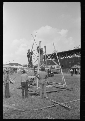 Setting up stand for mechanical amusement device, state fair, Donaldsonville, Louisiana