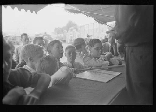 Boys standing at counter of concession, state fair, Donaldsonville, Louisiana