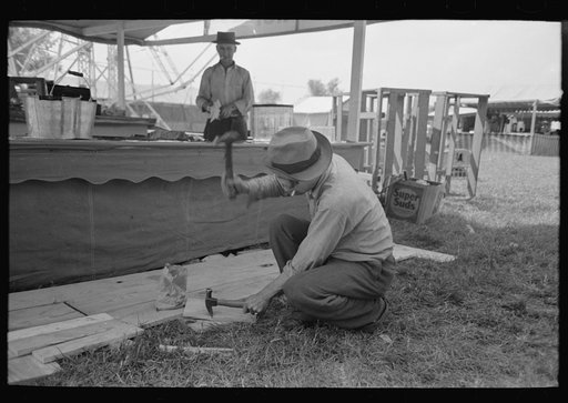 Untitled photo, possibly related to: Tossing rings at objects in concessions, state fair, Donaldsonville, Louisiana