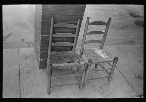 Chairs in front of hotel, with seats made of stretched tanned hide, Crowley, Louisiana