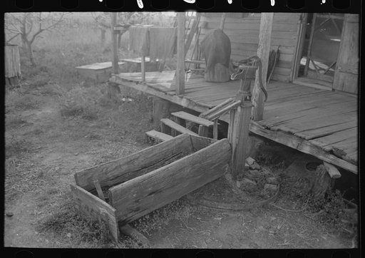 Primitive watering trough made from log at home of aged Cajun couple, near Crowley, Louisiana