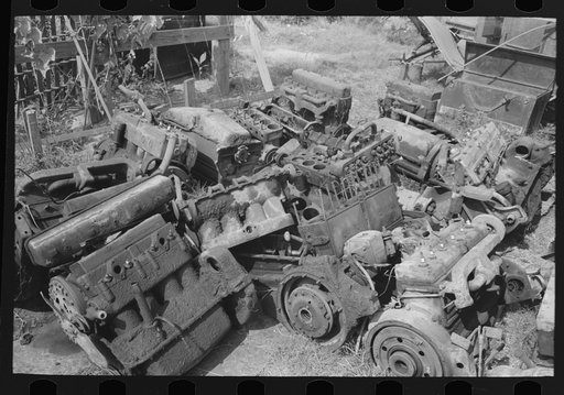 Discarded automobile motors at junkyard, Abbeville, Louisiana