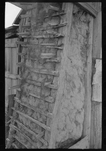 Detail of construction on hundred-year-old mud and moss chimney of farmhome of aged Cajun couple living near Crowley, Louisiana