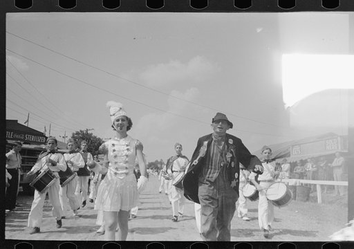 Drum majorette with clown, leading parade of the drum corps, state fair, Donaldsonville, Louisiana