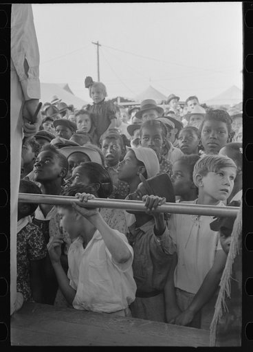 Children listening to barker at sideshow, state fair, Donaldsonville, Louisiana