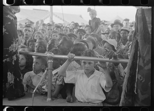 Untitled photo, possibly related to: Children listening to barker at sideshow, state fair, Donaldsonville, Louisiana