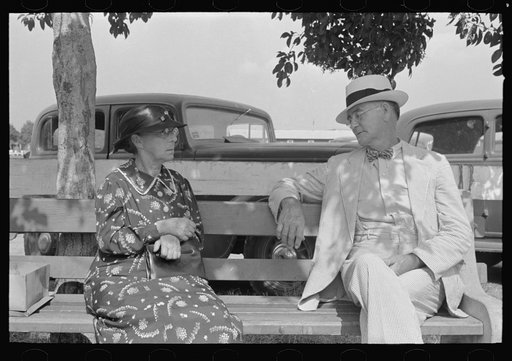 Couple sitting on bench, state fair, Donaldsonville, Louisiana