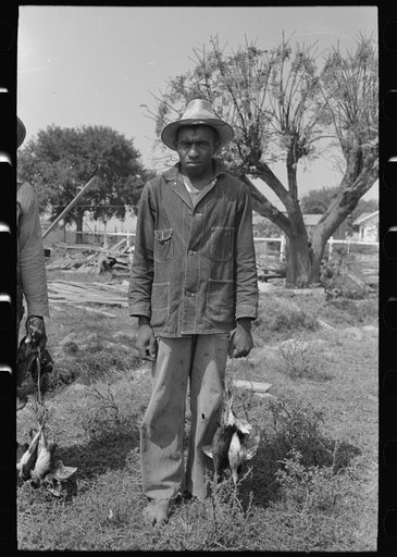 Untitled photo, possibly related to: Negro laborers employed by Joseph La Blanc, wealthy Cajun farmer, Crowley, Louisiana, with possum and birds they shot