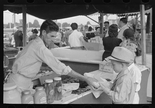 Little boy buying hamburger, state fair, Donaldsonville, Louisiana