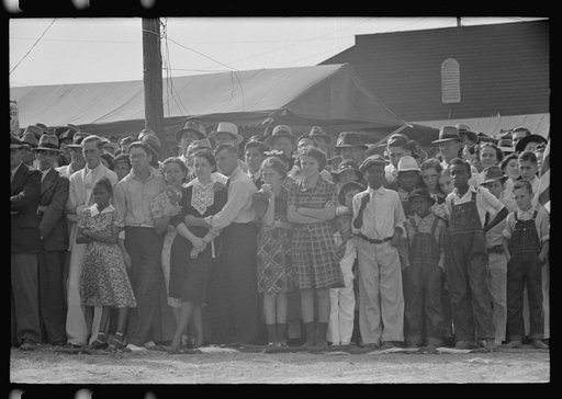 Untitled photo, possibly related to: Two boys leaning on fence watching parade, state fair, Donaldsonville, Louisiana