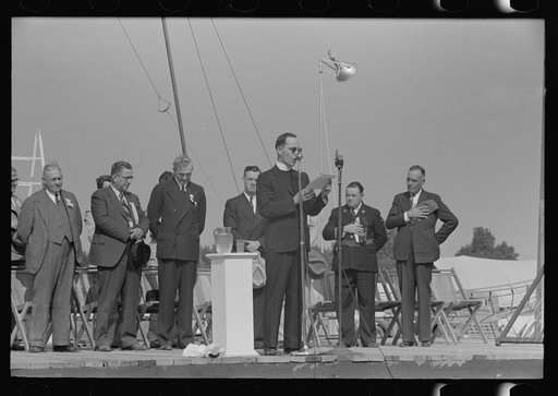 Chaplain praying from the main platform, opening the state fair, Donaldsonville, Louisiana
