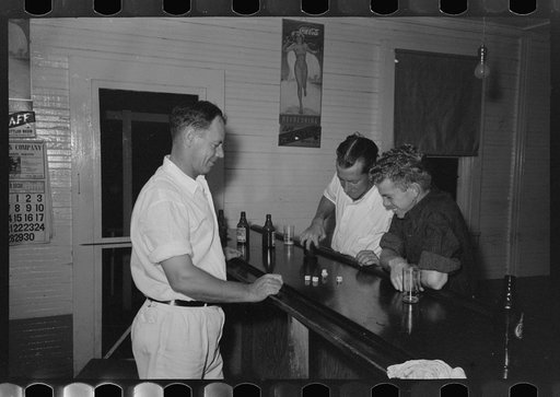 Playing game of "horses" with dice-shaking for the drinks, Pilottown, Louisiana