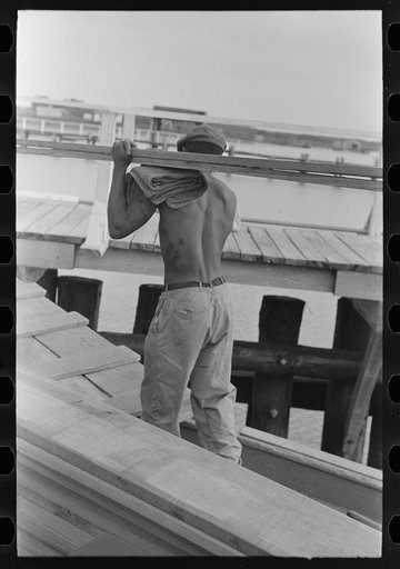 Negro stevedore removing lumber from packet boat "El Rito," Pilottown, Louisiana
