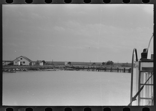 Untitled photo, possibly related to: Negro deck hand throwing line in docking operations, Burrwood, Louisiana