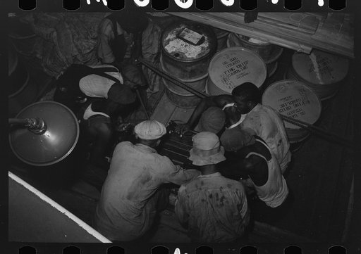 Untitled photo, possibly related to: Negro stevedores handling drum, New Orleans, Louisiana