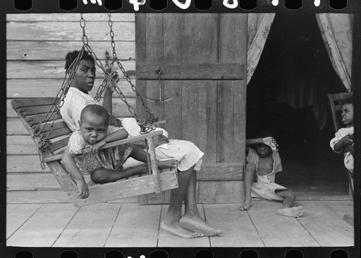 Negro mother with children on porch of home near Paulina, Louisiana