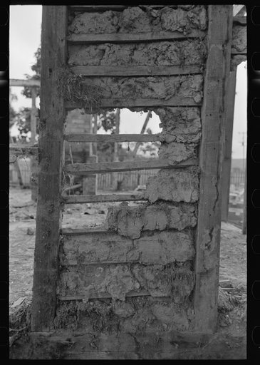 Detail of construction of old house; note the wooden cross lath. The construction material composed of mud and native moss. Near Edgard, Louisiana