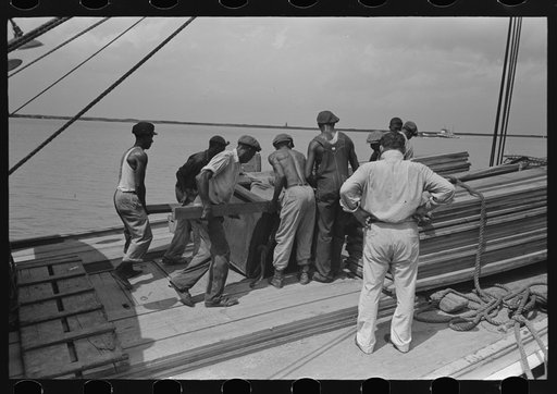 Stevedores at work on bow of packet boat El Rito on lower Mississippi River
