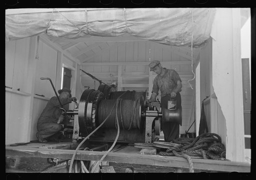 Painting elevating winches near Burrwood, Louisiana