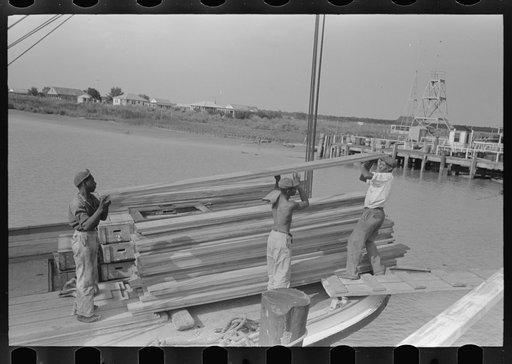 Untitled photo, possibly related to: Negro stevedores loading stove on boat, Burwood, Louisiana
