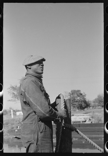 Untitled photo, possibly related to: Removing sugarcane from truck at sugar mill near New Iberia, Louisiana
