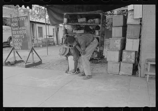 Untitled photo, possibly related to: Negro boy drawing on the sidewalk, New Iberia, Louisiana