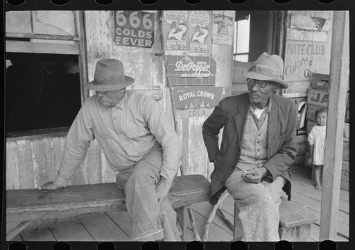 Untitled photo, possibly related to: Negroes talking on porch of small store near Jeanerette, Louisiana
