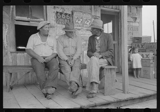 Untitled photo, possibly related to: Negroes talking on porch of small store near Jeanerette, Louisiana