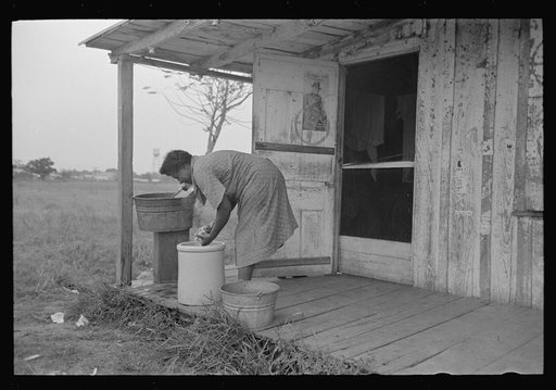 Untitled photo, possibly related to: Negroes talking on porch of small store near Jeanerette, Louisiana