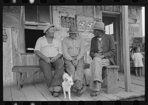 Negroes talking on porch of small store near Jeanerette, Louisiana
