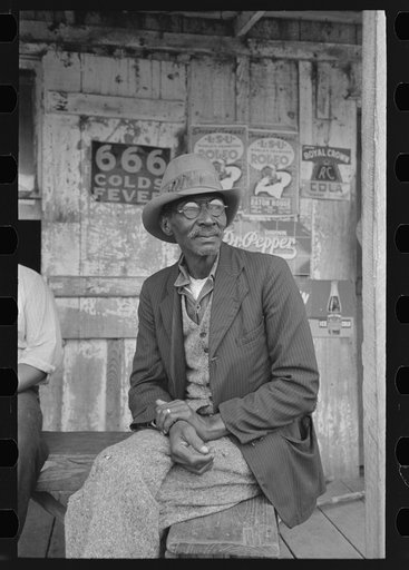 Negro on porch of general store near Jeanerette, Louisiana
