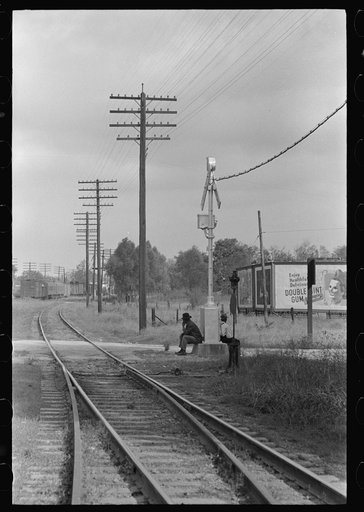 Men sitting on signal tower beside railroad track, Morgan City, Louisiana