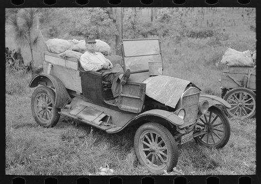 Farmer sitting in broken down Ford truck waiting for garageman near Amite, Louisiana