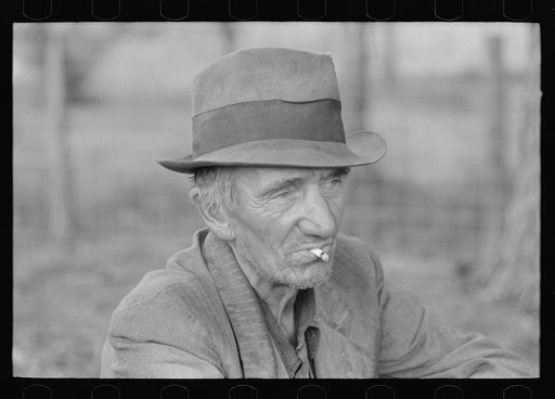 Migrant worker resting along roadside, Hancock County, Mississippi