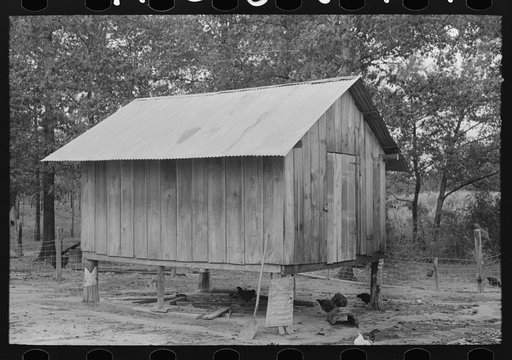 Shed on stilts belonging to farmer near Amite, Louisiana. Metal on stilts keeps out rats