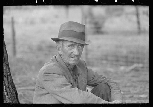 Migrant worker resting along roadside, Hancock County, Mississippi
