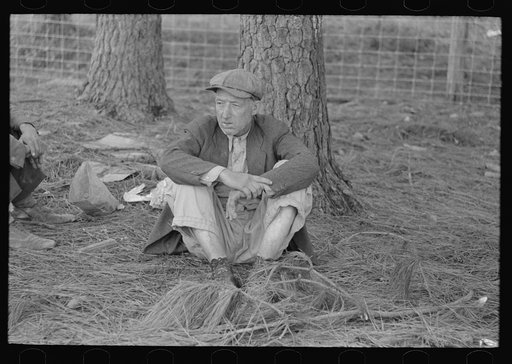 Migrant worker resting along roadside, Hancock County, Mississippi