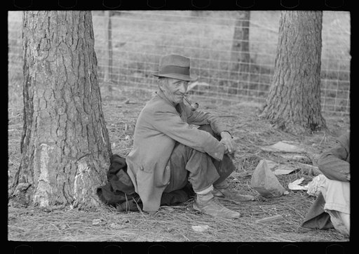 Migrant worker resting at roadside, Hancock County, Mississippi