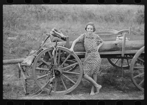 Untitled photo, possibly related to: Farm girl leaning on wagon, near Morganza, Louisiana