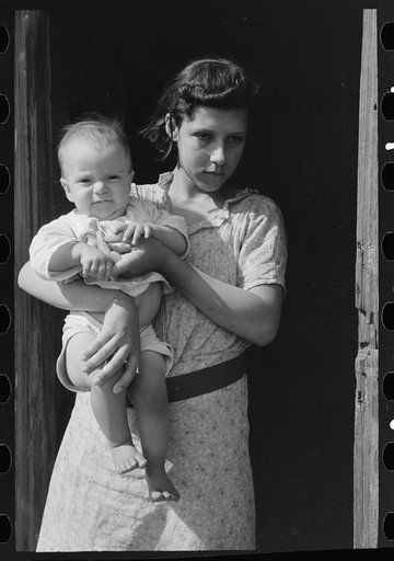 Wife and child of day laborers, sugarcane fields near New Iberia, Louisiana
