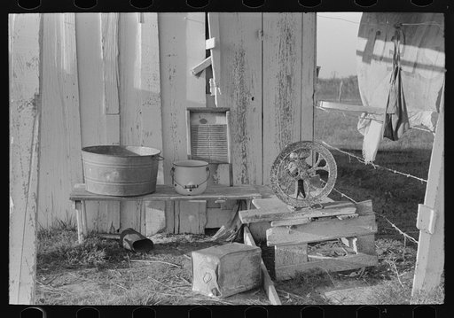 Laundry equipment and grain grinder on farm of Cajun sugarcane farmer near New Iberia, Louisiana