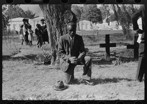 Untitled photo, possibly related to: Negro crossing himself and praying over grave of relative in cemetery, All Saints' Day, New Roads, Louisiana