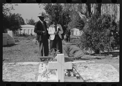 Negro couple at grave of relative, All Saints' Day in Cemetery at New Roads, Louisiana
