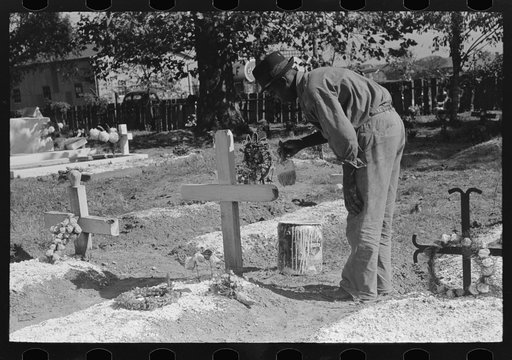 Untitled photo, possibly related to: Painting grave marker in cemetery, All Saints' Day in New Roads, Louisiana