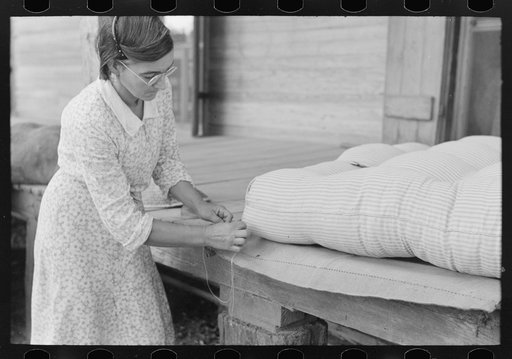 Wife of small cane farmer near Jarreau, Louisiana, making mattress of moss