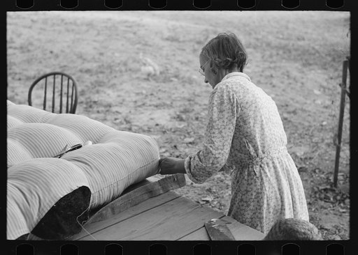 Untitled photo, possibly related to: Wife of small cane farmer near Jarreau, Louisiana, making mattress of moss
