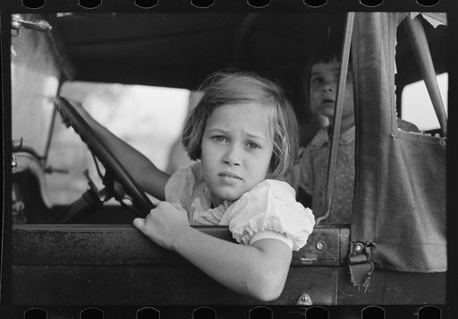 Untitled photo, possibly related to: Child of farmer sitting in automobile waiting for father to come out of general store, Jarreau, Louisiana